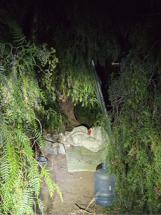 Homeless encampment cleanup at a commercial property in Southern California